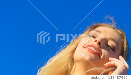 Face of young woman in sunlight 132487452