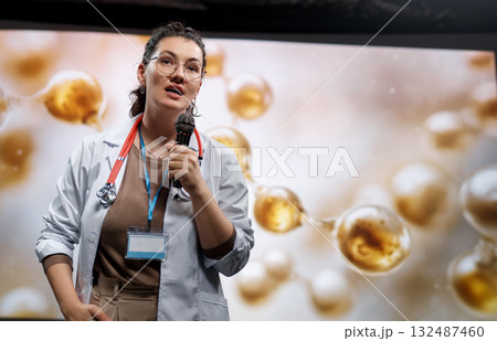 woman is giving a presentation at a conference woman is giving a presentation at a conference 132487460