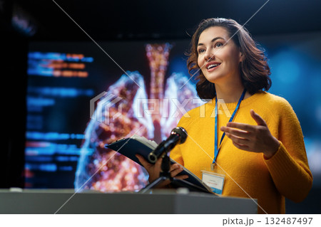 woman is giving a presentation at conference woman is giving a presentation at conference 132487497