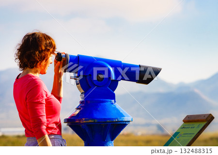 Woman using tourist binoculars, Cabo de Gata, Spain 132488315