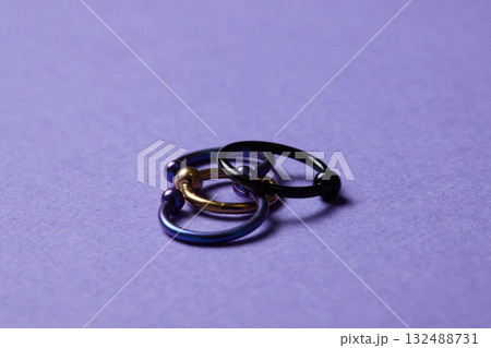 Piercing earrings close-up. On a black background. Piercing earrings close-up. On a black background. 132488731