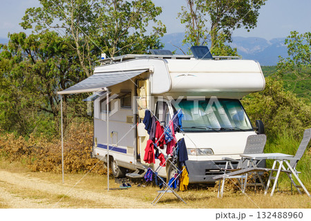 Clothes hanging to dry outdoors by camping car. Caravan vacation. 132488960