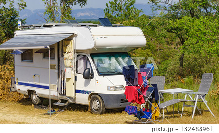 Clothes hanging to dry outdoors by camping car. Caravan vacation. 132488961