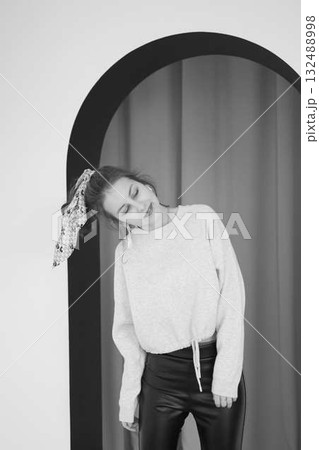 black and white portrait of a teenage girl in front of an arch black and white portrait of a teenage girl in front of an arch 132488998