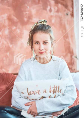 fragile teenage girl in bed hugging pillows 132489042
