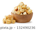 Bread croutons in a wooden plate and a pile on a white background. Isolated 132490236