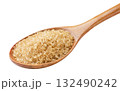Brown sugar crystals in a wooden spoon close-up on a white. Isolated 132490242