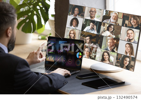 Businessman in virtual meeting presenting financial data charts with confident expression. Bright poster 132490574