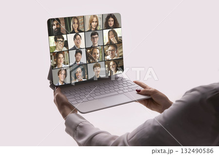 Creative digital artwork. Woman holding laptop during cheerful international video meeting 132490586