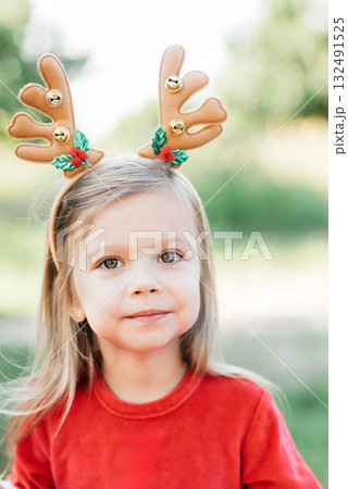 Christmas in july. Child waiting for Christmas in wood in july. portrait of little girl drinking hot cocoa with marshmallow and gingerBread man cookies. Merry Christmas and Happy Holidays. Christmas in july. Child waiting for Christmas in wood in july. portrait of little girl drinking hot cocoa with marshmallow and gingerBread man cookies. Merry Christmas and Happy Holidays. 132491525