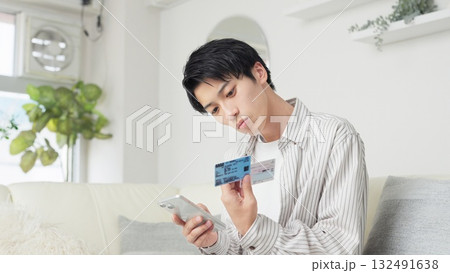 マイナ保険証を設定するアジア人男性 132491638