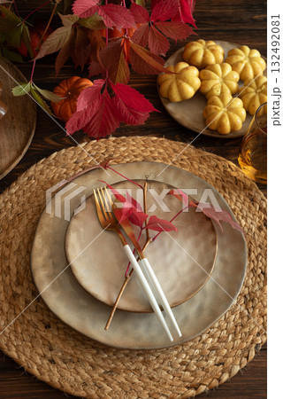 Festive Autumn Table Setting with Ceramic Plates, Pumpkins, Cake and Rustic Decor Festive Autumn Table Setting with Ceramic Plates, Pumpkins, Cake and Rustic Decor 132492081