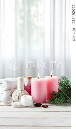 Vertical holiday spa scene with soft light, spa accessories and pine decorations. Copy space 132492099