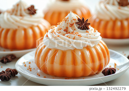 For friendly baking blogs. Pumpkin dessert in orange tones on a plate with soft lighting. Preparing for Halloween. Autumn atmosphere. 132492279