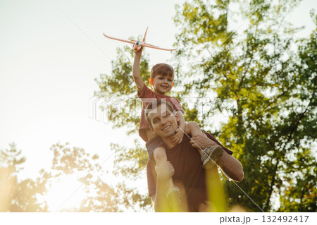 Portrait of happy father with son outdoors. Portrait of happy father with son outdoors. 132492417