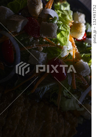 Cross Up Fried Chicken Salad With Mixed Veggies, A close up of crispy fried chicken salad with mix veggies, vibrant greens and gold bites glistening under light, perfect for food photo or fresh meal. Cross Up Fried Chicken Salad With Mixed Veggies, A close up of crispy fried chicken salad with mix veggies, vibrant greens and gold bites glistening under light, perfect for food photo or fresh meal. 132493752