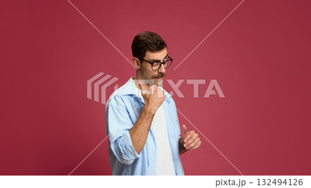 Doubtful man pointing thumb to side with skeptical facial expression Doubtful man pointing thumb to side with skeptical facial expression 132494126