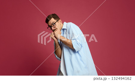 Nervous man covering face with fists expressing fear and anxiety Nervous man covering face with fists expressing fear and anxiety 132494162