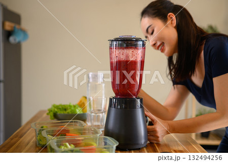 Photo set of a woman making a fruit smoothie in her home kitchen, reflecting a healthy and balanced daily lifestyle 132494256