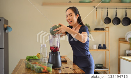 Photo set of a woman making a fruit smoothie in her home kitchen, reflecting a healthy and balanced daily lifestyle 132494716