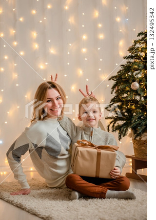 Mother and Child Laughing with Holiday Gift 132495342