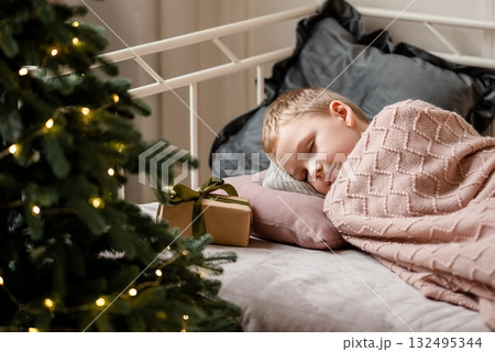 Child Sleeping Peacefully on Christmas Morning Near Gifts Child Sleeping Peacefully on Christmas Morning Near Gifts 132495344