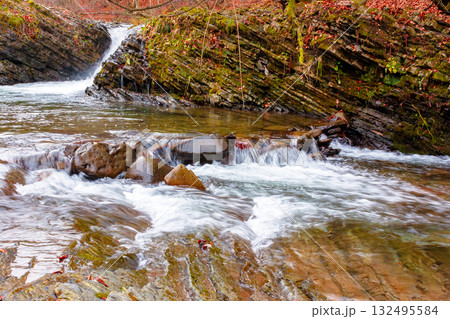 small waterfall on the turichka river in the forest near lumshory village of transcarpathia, ukraine. low angle view of the shore. beautiful autumnal scenery. popular travel destination. wide angle small waterfall on the turichka river in the forest near lumshory village of transcarpathia, ukraine. low angle view of the shore. beautiful autumnal scenery. popular travel destination. wide angle 132495584