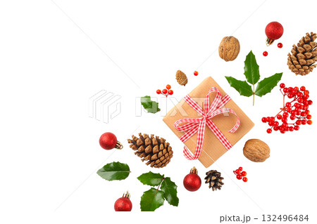Wrapped Christmas gift with holiday decor nearby Wrapped Christmas gift with holiday decor nearby 132496484