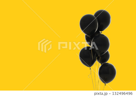 Black balloons arranged on a yellow background 132496496