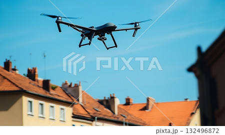Drone soaring above rooftops during a sunny day, capturing aerial views in an urban area 132496872