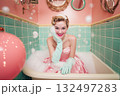 A woman in a pink dress is sitting in a bathtub with bubbles 132497283