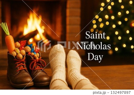 Saint nicholas day celebration with shoes filled with treats near cozy fireplace 132497897