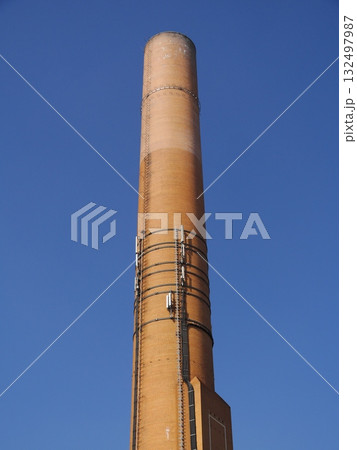 Tall brick tower with a blue sky in the background Tall brick tower with a blue sky in the background 132497987