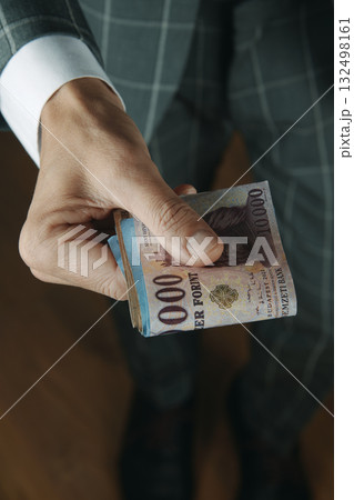 man holding Hungarian forint banknotes man holding Hungarian forint banknotes 132498161