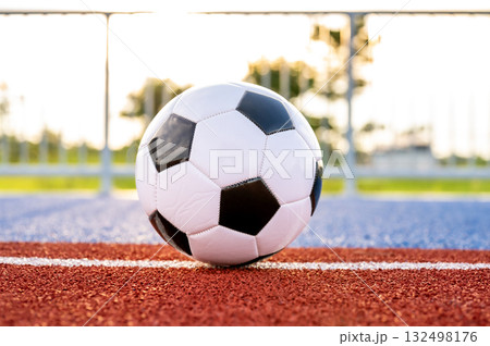 Footballs on the field and goal nets in a large stadium Footballs on the field and goal nets in a large stadium 132498176