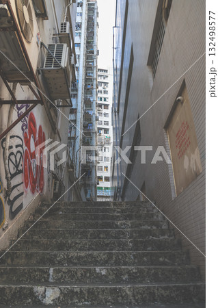 18 Oct 2025 Hidden alley with neon lights and urban textures 132498577