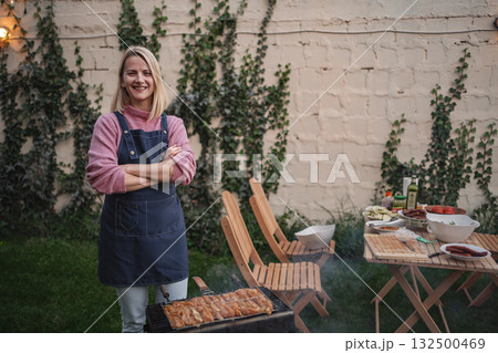 Barbecue gathering with friends in a cozy backyard during sunset Barbecue gathering with friends in a cozy backyard during sunset 132500469