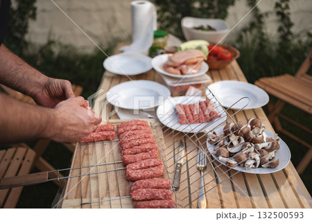 Preparing a flavorful barbecue feast in a vibrant backyard setting Preparing a flavorful barbecue feast in a vibrant backyard setting 132500593