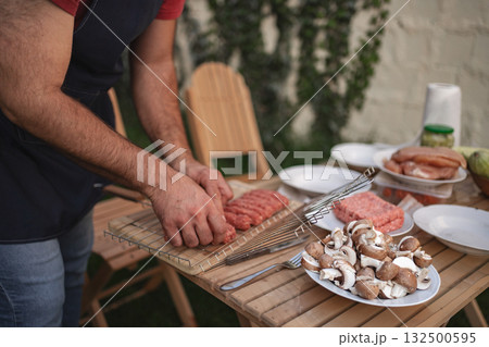 Grilling vibrant sausages and fresh mushrooms in a backyard gathering Grilling vibrant sausages and fresh mushrooms in a backyard gathering 132500595