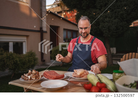 Outdoor cooking experience with fresh ingredients in a cozy backyard setting Outdoor cooking experience with fresh ingredients in a cozy backyard setting 132500597