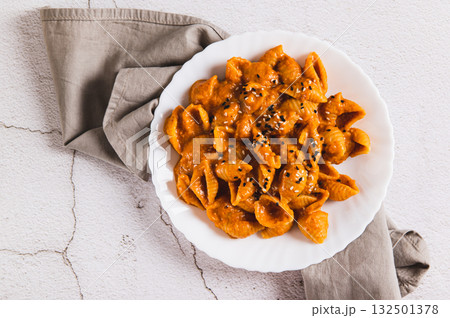 Close up of spicy miso pasta shells on a plate on the table top view Close up of spicy miso pasta shells on a plate on the table top view 132501378