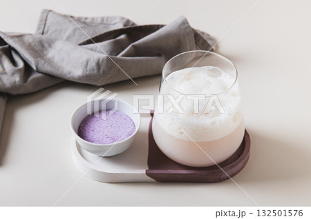 Cloudy pink matcha in a glass and powder in a bowl on the table Cloudy pink matcha in a glass and powder in a bowl on the table 132501576