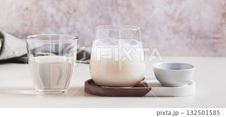 Cloudy pink matcha with coconut water in a glass on the table web banner 132501585