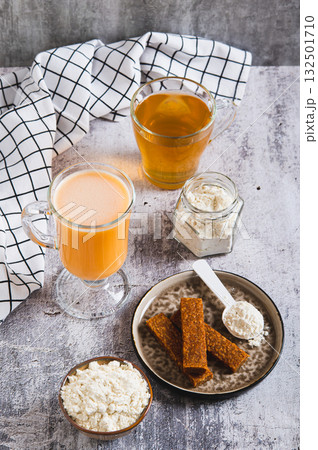 Protein nutrition and green tea for skin microbiome care set on the table vertical view 132501710