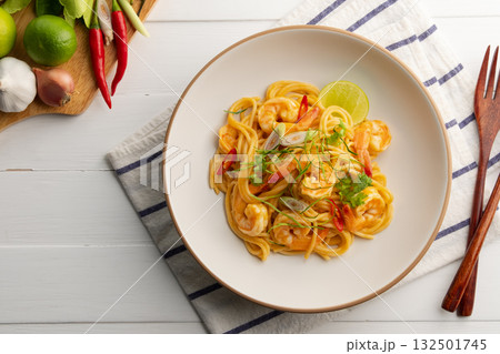 Creamy Spaghetti Tom Yum Kung,Thai style fusion food, spicy pasta with shrimp in tom yum sauce.Top view. Creamy Spaghetti Tom Yum Kung,Thai style fusion food, spicy pasta with shrimp in tom yum sauce.Top view. 132501745