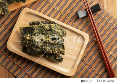 snack seaweed tempura chips,Deep fried Crispy Seaweed with flour, egg on a plate.Top view. snack seaweed tempura chips,Deep fried Crispy Seaweed with flour, egg on a plate.Top view. 132501828