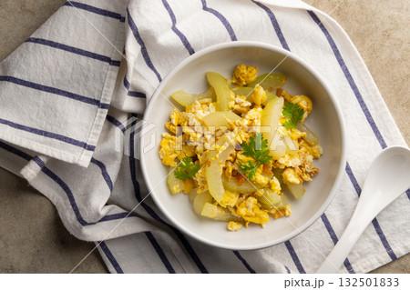 Stir Fried Winter Melon with Egg in white bowl.Top view. Stir Fried Winter Melon with Egg in white bowl.Top view. 132501833