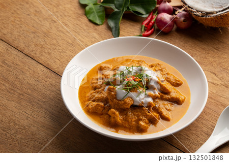 Panaeng Curry with pork.Sliced pork Meat in red curry paste and coconut milk,topping with coconut cream and Shredded kaffir lime leaves.Thai style food. 132501848