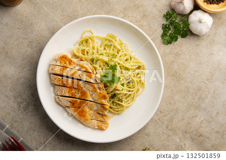 Grilled Chicken breast with spaghetti broccoli pesto sauce in a plate.Top view. 132501859