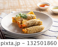 Deep Fried Crispy Wonton wrapped with shrimp and minced pork in white plate.Thai appetizer food with Sweet Chili Sauce and seafood sauce. 132501860